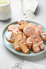 Plate with gingerbread cookies on table
