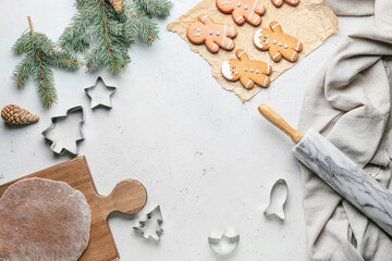 Gingerbread cookies, fresh dough and cutters on white background