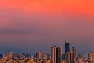 The high angle background of the city view with the secret light of the evening, blurring of night lights, showing the distribution of condominiums, dense homes in the capital community