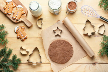 Composition with gingerbread cookies and ingredients on wooden background