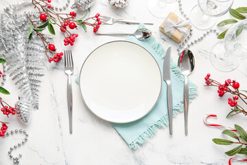 Beautiful Christmas table setting with mistletoe on white background