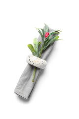 Napkin with mistletoe for Christmas dinner on white background