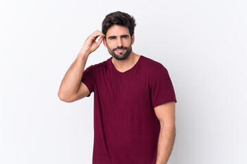Fototapeta premium Young handsome man with beard over isolated white background having doubts