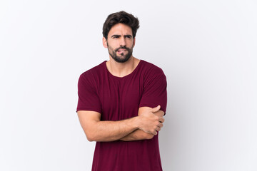 Fototapeta premium Young handsome man with beard over isolated white background with confuse face expression
