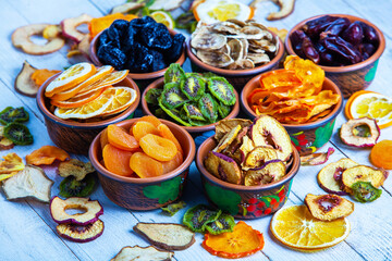 Organic Healthy Assorted Dried Fruit Mix close up. Dried fruit snacks. dried apples, mango, feijoa, dried apricots, prunes top view