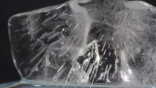 ice cube on black background macro shot 4k