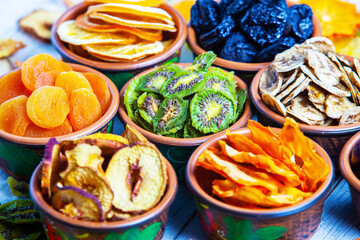 Organic Healthy Assorted Dried Fruit Mix close up. Dried fruit snacks. dried apples, mango, feijoa, dried apricots, prunes top view
