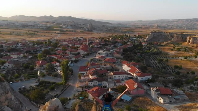 Aerial drone view of Cavusin village, Goreme, Cappadocia, Turkey. Tourist woman and tipical turkish village