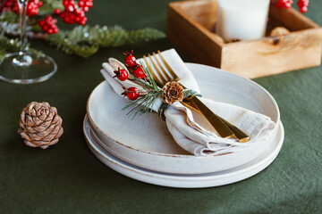 Festive table setting with winter decor. The concept of Thanksgiving or Christmas family dinner.