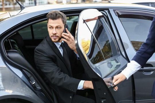 Businessman getting out of luxury car