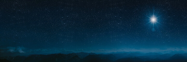 The star shines over the manger of christmas of Jesus Christ.