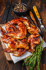 Baked Bbq chicken wings  with dip sauce. Dark wooden background. Top view