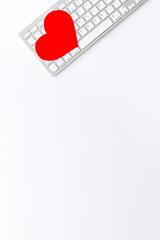 Love emotion - online dating concept. Heart on the keyboard, top view