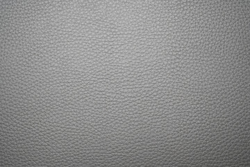 a soft-textured grey leather background consisting of lines of a constant pattern.