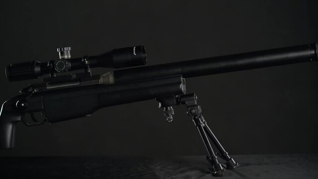 focus and pan from the top of the silencer to the butt of Sniper rifle Sako TRG 41 on black background