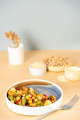 Homemade vegetarian stewed chick-pea chickpeas with vegetables. Style minimalism. Selective focus. On plate bowl close up. Concept healthy vegan diet protein organic brain food dish