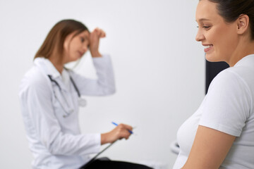 Fototapeta premium Gynecologist providing medical diagnostic for pregnant woman