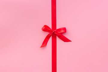 Red ribbon with bow for holiday gift box. Top view, copy space