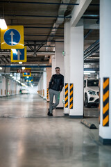 Portrait of a handsome young man. Shooting in a car park