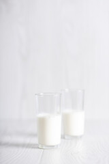 milk in a glass on a light background. Breakfast. Milk cocktail preparation process. Copyspace