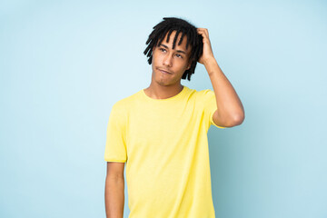 Young african american man isolated on blue background with an expression of frustration and not understanding