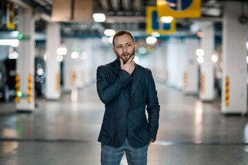 Portrait of a handsome young man. Shooting in a car park
