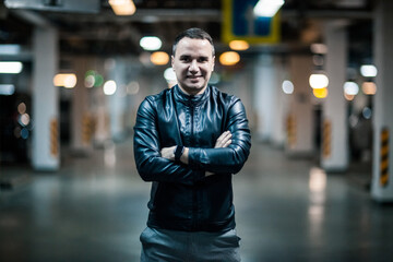 Portrait of a handsome young man. Shooting in a car park
