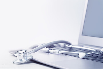 Stethoscope on a laptop. Virus season, pandemic. Remote medicine or e-learning and telemedicine and...