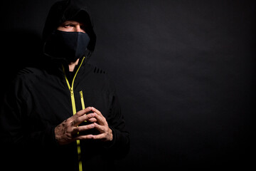 Portrait of Invisible man hacker in the hood isolated on black background