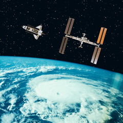 Shuttle and satellite above the earth. The elements of this image furnished by NASA.