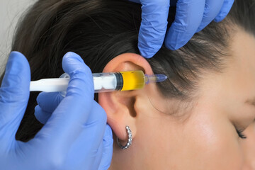 Doctor trichologist making injections mesotherapy with vitamins in woman's skin head for hair growth and against dandruff in cosmetology clinic. Hairs cure. Trichology in medicine.