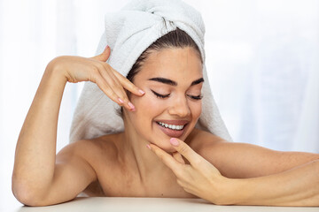 Obraz na płótnie Canvas Cosmetology, beauty and spa. perfect woman with white towel on head after shower having toothy smile touch gently healthy shiny clean skin looking at camera, skincare and natural beauty