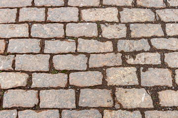 Old wet granite cobblestone road