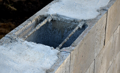 construction of a concrete wall from concrete blocks filled inside with reinforcing steel and...