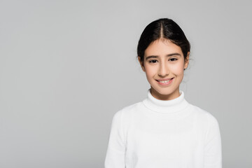 Positive hispanic child looking at camera isolated on grey