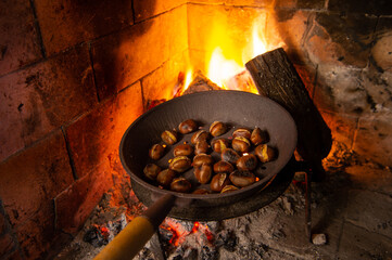 chestnuts grilling on the smoldering fire, italian chestnut from Viterbo Area