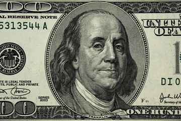 United States hundred dollars money bill closeup. Portrait of US president Benjamin Franklin on 100...