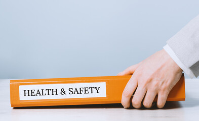 Health and safety labor protection and regulations at work place. Folder with documents or...