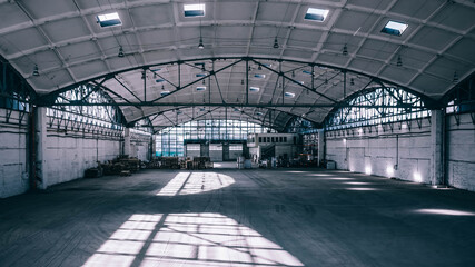 Huge industrial warehouse. Modern interior. Unique architecture. Hemispherical reinforced concrete load bearing roof. Stack wooden pallets.