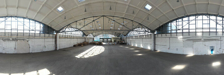 360 degree spherical seamless panorama of huge industrial warehouse. Hemispherical reinforced concrete load bearing roof. Wooden pallets. Unique atchitecture.