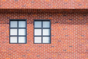 2 glass windows on brick wall of vintage house building