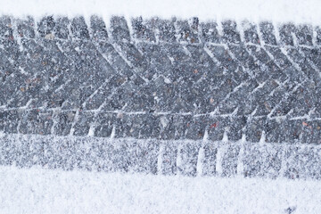 Car tread marks on snow.