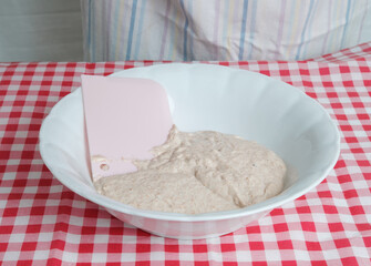 Kneading a dough of bread in a bowl. Female hands working. Making pizza. Cooking at home. Homemade food. Italian cloth.