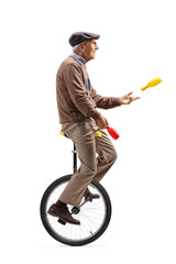 Elderly man a riding a unicycle and juggling © Ljupco Smokovski