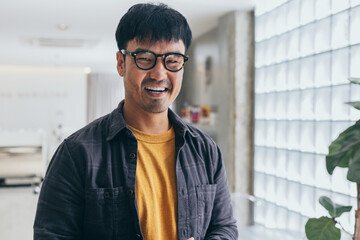 asian man portrait young male wear eye glasses smiling cheerful look thinking position with perfect clean skin posing on cafe background.fashion people life style concept