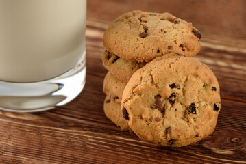 Tasty cookies and glass of milk on  wooden background