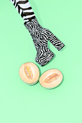 Girl in sexy zebra print shoes with fresh melon Tropically africa mood fresh concept