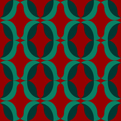 Repeating, seamless pattern of abstract leaf shapes on red background.  Ideal for wrapping paper or greeting card design for Christmas holidays.