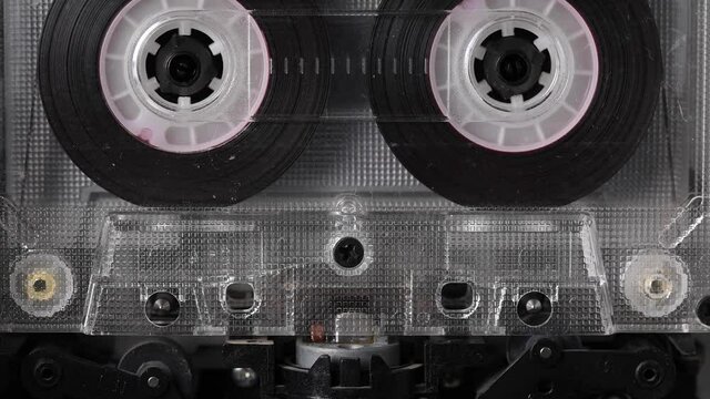 Vintage audio cassette tape playing. Rotation of rolls of film. Close up footage