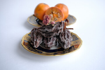 dried fruits. dried persimmon fruit on a plate. Kaki plum fruit, Japanese persimmon, Diospyros kaki Lycopersicum